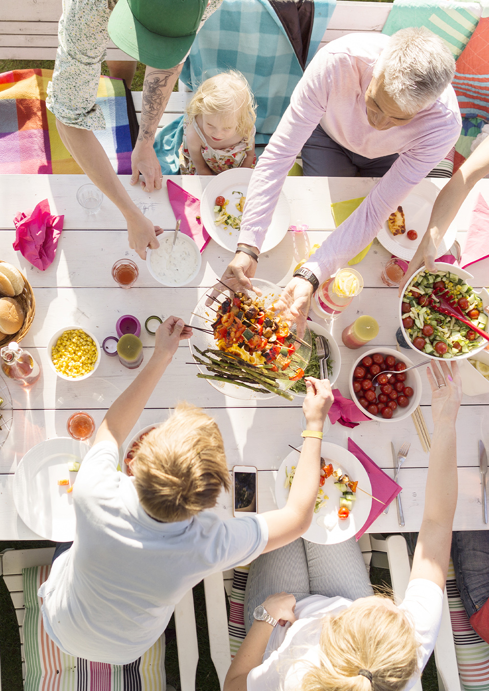 People sitting at table at garden party