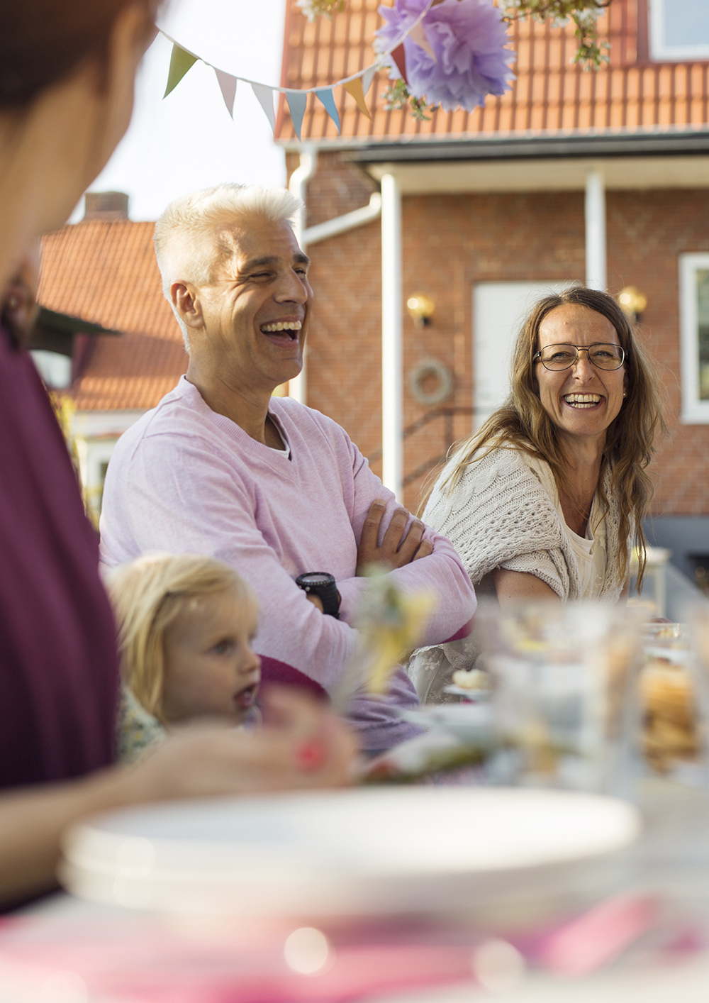 People sitting at table at garden party